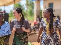 Women within a community in Malawi dance with Columbia Nursing student Karen K. Hsu.